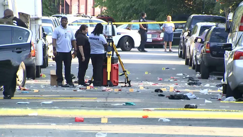 In this image from video provided by NBC4 Washington, law enforcement work the scene of a shooting, Sunday, Aug. 9, 2020, in Southeast Washington. (NBC4 Washington via AP)