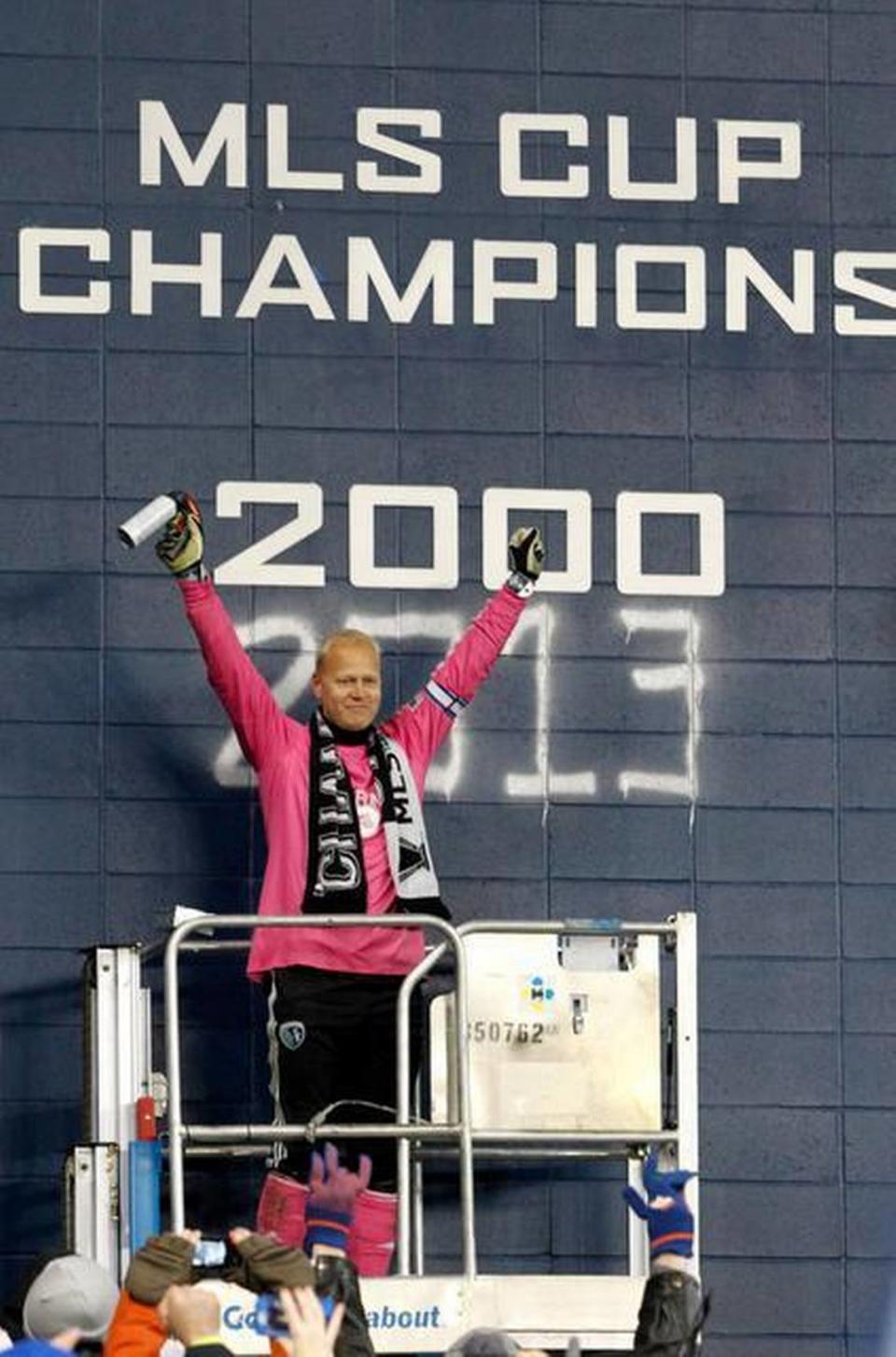 Sporting Kansas City goalkeeper Jimmy Nielsen acknowledges the fans after painting the wall in commemoration of the team’s 2013 MLS Cup championship.