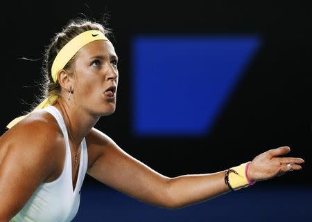 Victoria Azarenka of Belarus reacts after missing a shot against Dominika Cibulkova of Slovakia during their women's singles fourth round match at the Australian Open 2015 tennis tournament in Melbourne January 26, 2015. REUTERS/Athit Perawongmetha