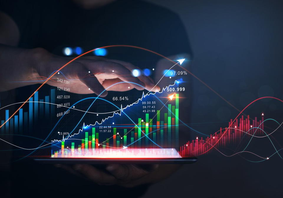 A hand hovering above a holographic stock chart.