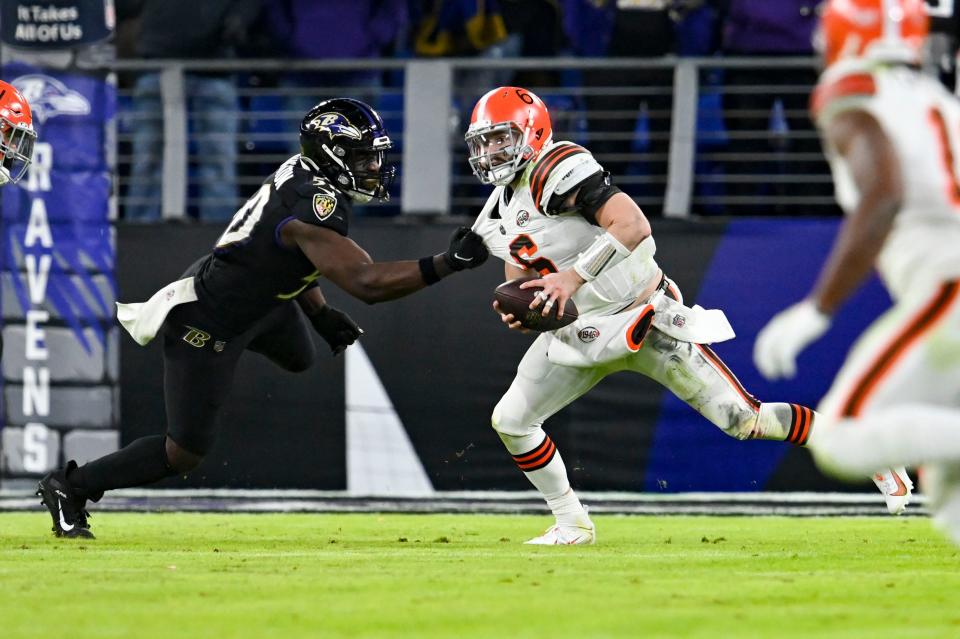 Nov 28, 2021; Baltimore, Maryland, USA; Baltimore Ravens outside linebacker Justin Houston (50) grabs Cleveland Browns quarterback Baker Mayfield (6) during the second half  at M&T Bank Stadium. Mandatory Credit: Tommy Gilligan-USA TODAY Sports