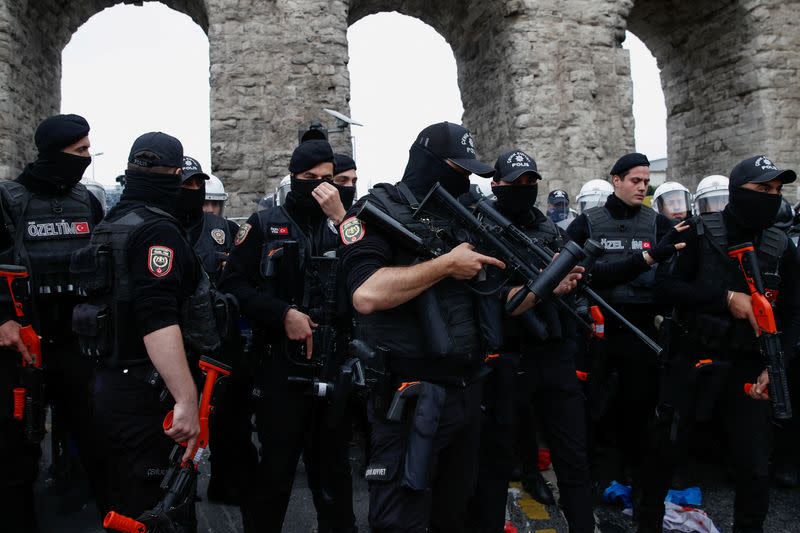 Turkish police officers block a main road to prevent May Day demonstrators from marching through Taksim Square in Istanbul