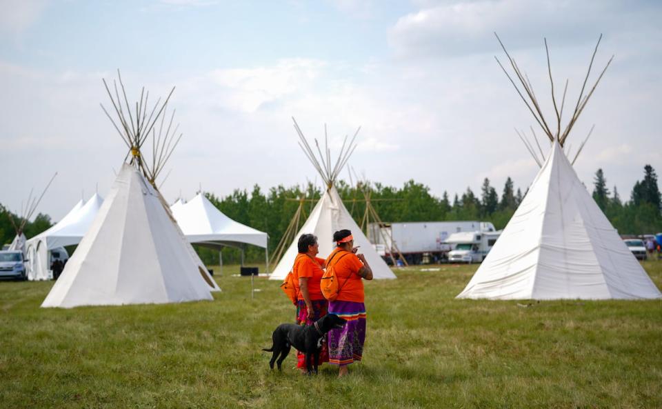 Two people look on after the grand opening of Federation of Sovereign Indigenous Nations (FSIN) Traditional Health Gathering at James Smith Cree Nation, Sask., on Monday, August 21, 2023.