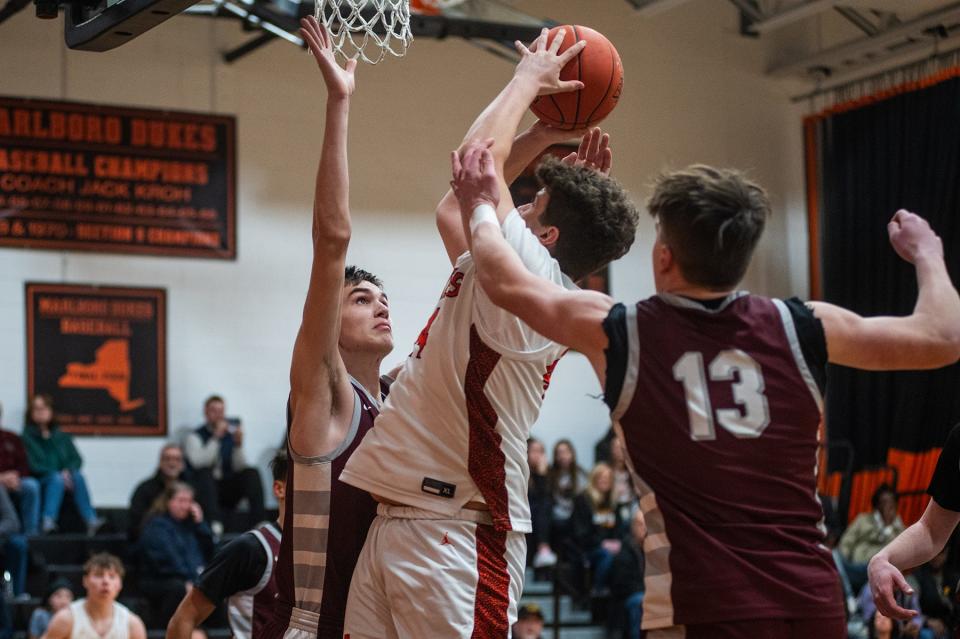 New Paltz's Russell Patterson, left, blocks Marlboro's Thomas Benfer's shot during the Section 9 boys basketball game at Marlboro High School in Marlboro, NY on Friday, February 2, 2024. New Paltz defeated Marlboro 55-70. KELLY MARSH/FOR THE POUGHKEEPSIE JOURNAL