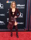 <p>Here she is at the 2018 Billboard Awards wearing a leather-look getup with matching boots, abs peeping through.</p>