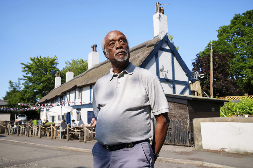 Clinton Smith, chair of Preston Black History Group is seen by the Ye Olde Hob Inn in Bamber Bridge near Preston, England, Thursday, June 22, 2023. What is now known as the Battle of Bamber Bridge erupted there on June 24, 1943 when white military police officers confronted black soldiers enjoying a night off in the local pub. (AP Photo/Jon Super)