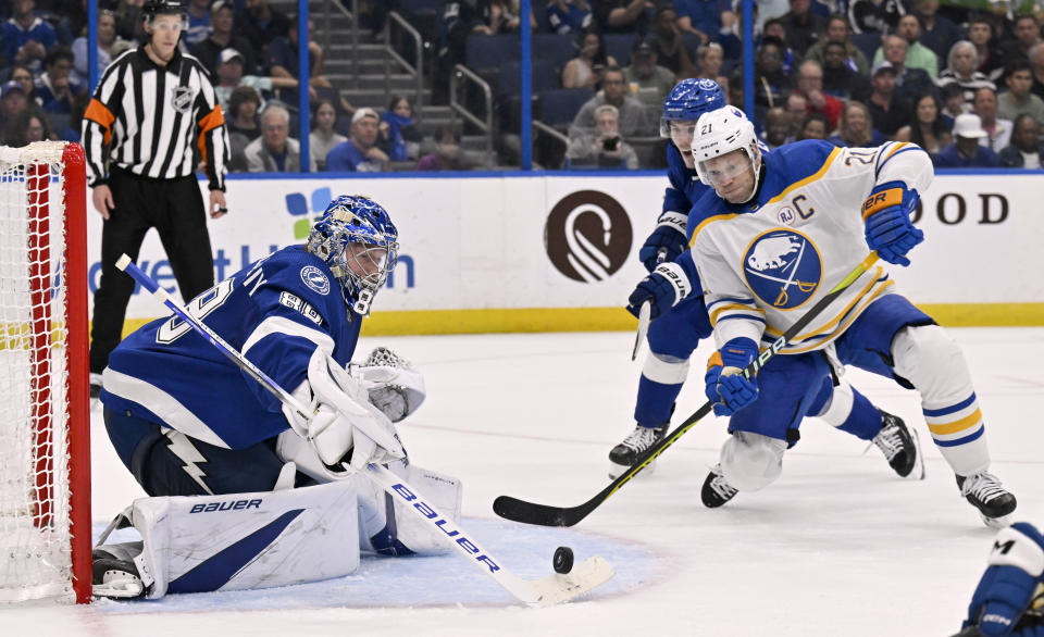 Tampa Bay Lightning goaltender Andrei Vasilevskiy (88) stops a pass from getting to Buffalo Sabres right wing Kyle Okposo (21) during the third period of an NHL hockey game Thursday, Feb. 29, 2024, in Tampa, Fla. (AP Photo/Jason Behnken)