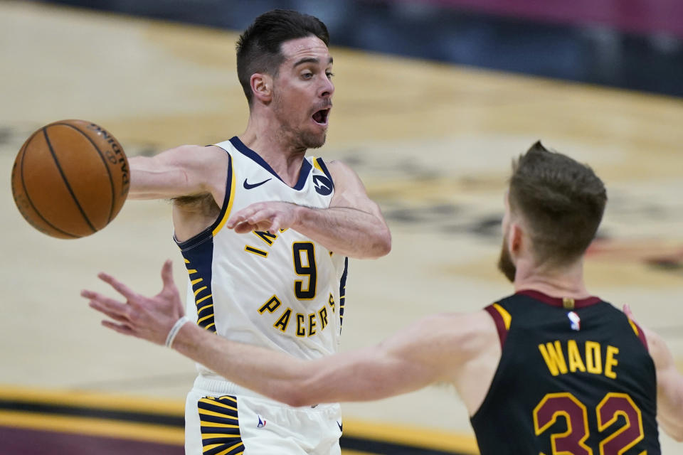 Indiana Pacers' T.J. McConnell (9) passes the ball away from Cleveland Cavaliers' Dean Wade (32) during the second half of an NBA basketball game, Wednesday, March 3, 2021, in Cleveland. (AP Photo/Tony Dejak)