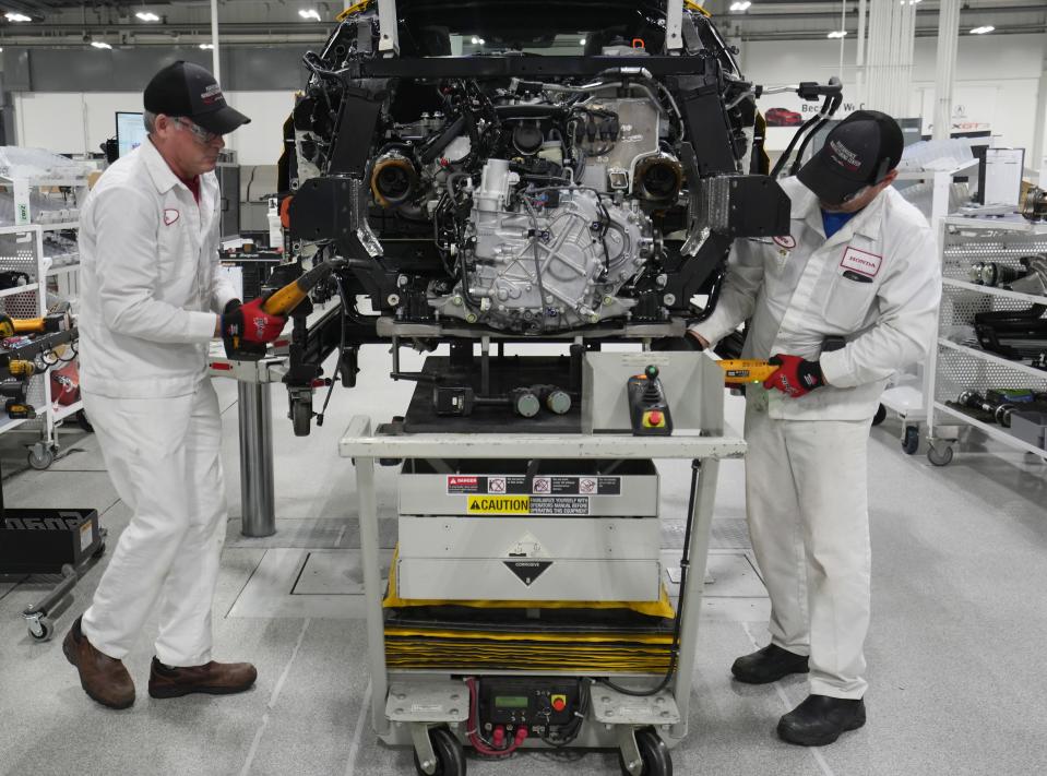 Jon Osler (left) and Gene Bowshier mount an engine on one of the last  of 350 Acura NSX sports cars built at the Performance Manufacturing Center near Marysville.