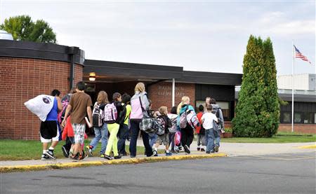 Students arrive for class at Mahnomen Elementary School in Mahnomen, Minnesota September 26, 2013. REUTERS/Dan Koeck