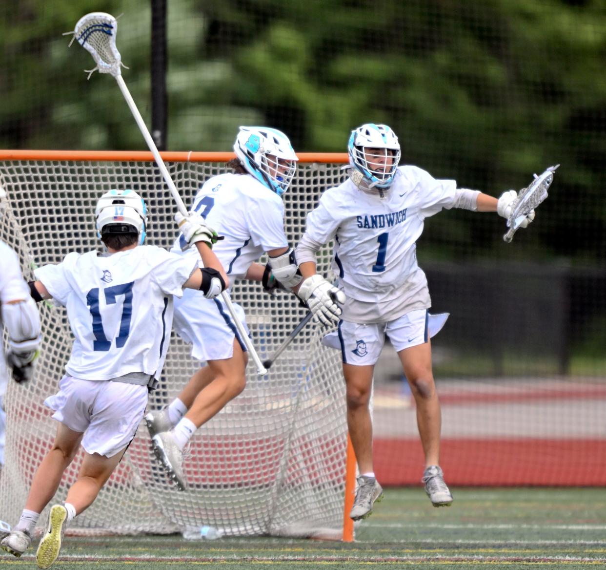 Shane Corcoran is joined by his teammates after beating Dover-Sherborn 7-6 in boys Division 4 final four lacrosse.