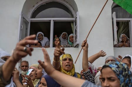 The Wider Image: Barricades and books in restive Kashmir neighbourhood