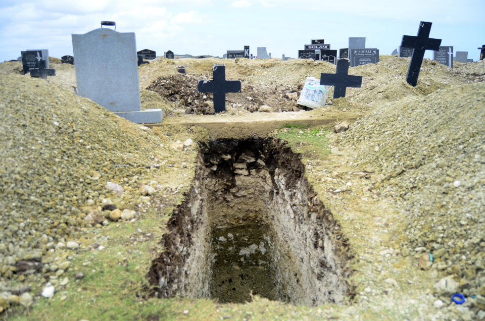 A freshly-dug grave sits at the Motherwell Cemetery in Port Elizabeth, South Africa, Friday, Dec. 4, 2020. Health Minister Zweli Mkhize announced on Wednesday, Dec. 9, 2020 that the country is now experiencing a Covid-19 pandemic second wave. (AP Photo/Theo Jeftha)