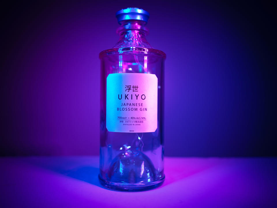 Hasselblad 907X & CFV 100C sample image of an alcohol bottle lit with pink and blue lighting