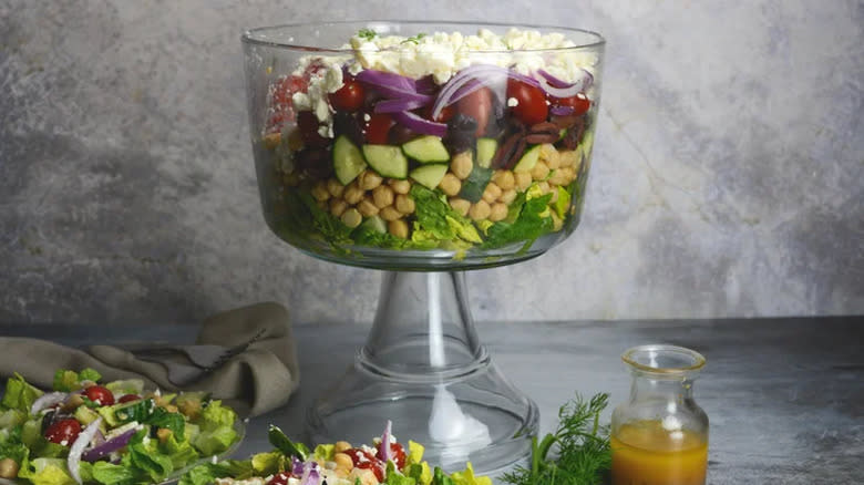 Seven layer Greek salad in trifle bowl