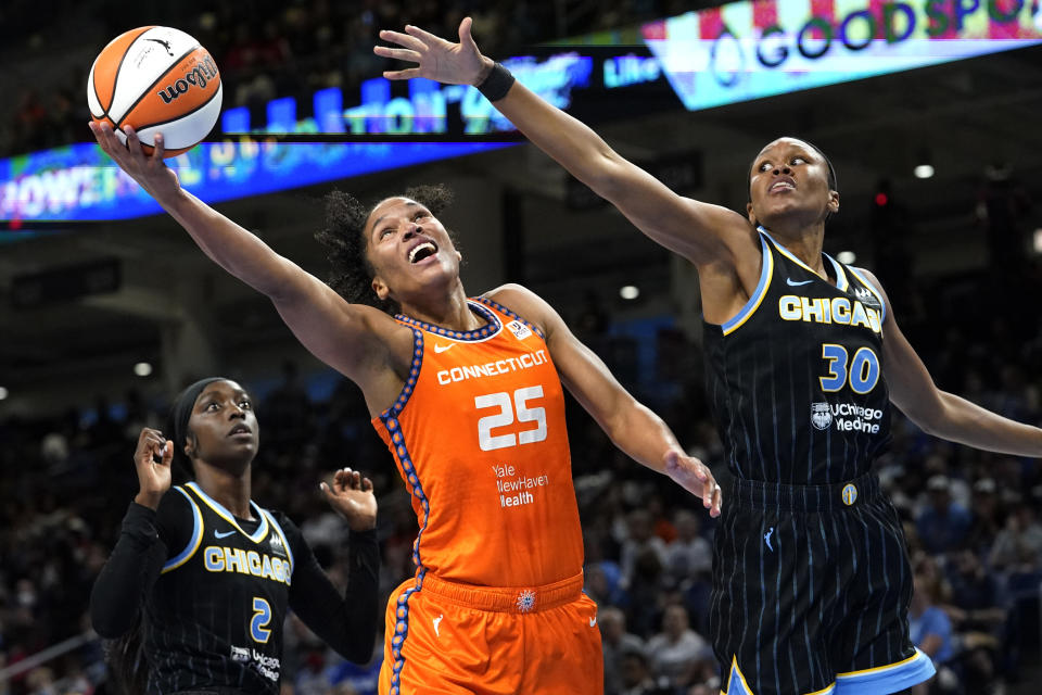 Connecticut Sun's Alyssa Thomas (25) shoots as Chicago Sky's Azura Stevens, right, defends, and Kahleah Copper watches during the first half of Game 2 in a WNBA basketball playoffs semifinal Wednesday, Aug. 31, 2022, in Chicago. (AP Photo/Nam Y. Huh)