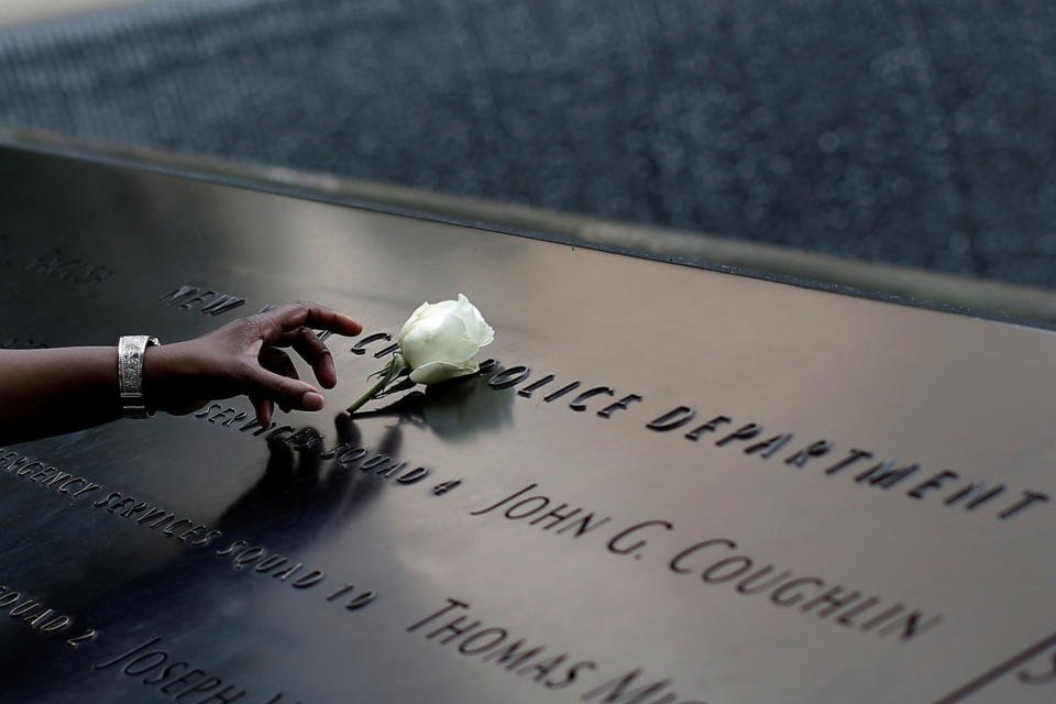 White rose at the edge of the South Pool of the 9/11 Memorial