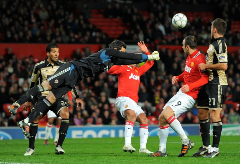 Benfica's players fight for the ball with Manchester United's footballers during an UEFA Champions League match at Old Trafford in Manchester, in 2011