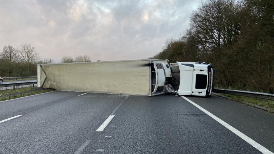 Falmouth Packet: The lorry on its side after overturning on the M5