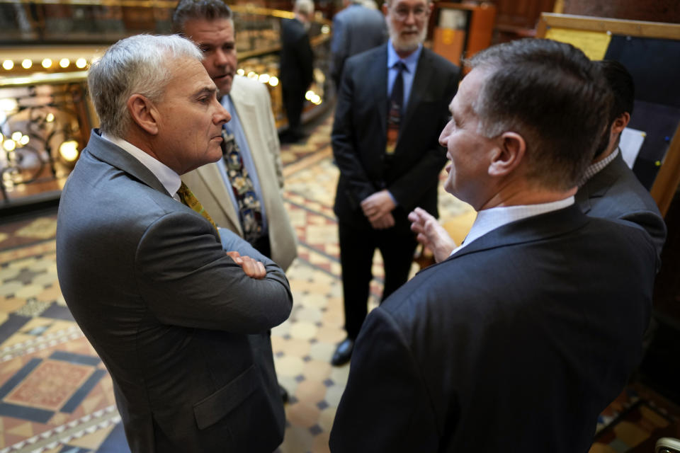 Rev. Kerry Jech, of Marshalltown, Iowa, left, talks with State Rep. Bill Gustoff, right, Thursday, April 6, 2023, at the Statehouse in Des Moines, Iowa. (AP Photo/Charlie Neibergall)