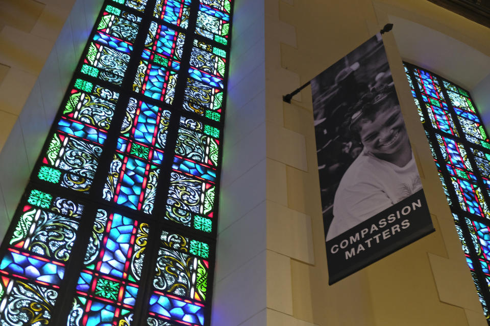 In this Tuesday, Feb. 12, 2019 photo, a banner hangs by a stained glass window in the sanctuary at Glide Memorial United Methodist Church in San Francisco. The United Methodist Church officially opens its top legislative assembly Sunday, Feb. 24, 2019, for a high-stakes three-day meeting likely to determine whether America's second-largest Protestant denomination will fracture due to long-simmering divisions over same-sex marriage and the ordination of LGBT clergy. (AP Photo/Eric Risberg)