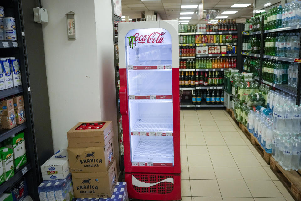An empty CocaCola refrigerator is seen at a grocery shop in Zagreb, Croatia, Wednesday, Nov. 8, 2023. Authorities in Croatia on Wednesday recommended people drink only tap water as they investigated reports of several cases of people getting sick and suffering injuries allegedly after consuming bottled beverages. They did not say which products were being withdrawn, but photos on social media from shops suggested they were Coca-Cola brands. (AP Photo/Darko Bandic)