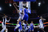 Orlando Magic's Franz Wagner, left, cannot get a shot past Philadelphia 76ers' Andre Drummond during the first half of an NBA basketball game, Monday, Nov. 29, 2021, in Philadelphia. (AP Photo/Matt Slocum)