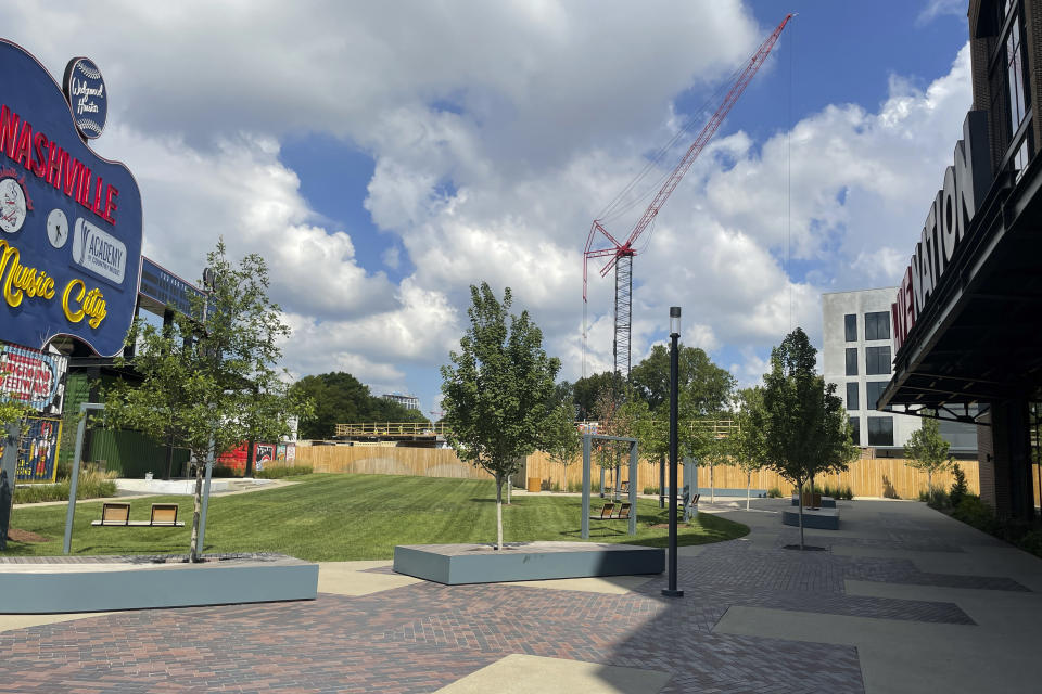 A revamped, guitar-shaped scoreboard, which was part of Greer Stadium, a former home for minor league baseball in Nashville, Tenn., stands now as a part of the Wedgewood-Houston development site Aug. 12, 2022, in Nashville. A developer says it has unearthed human remains that could be two centuries old while digging to lay the foundation of the project not far from a Civil War fort and a cemetery dating back to 1822. (AP Photo/Jonathan Mattise)