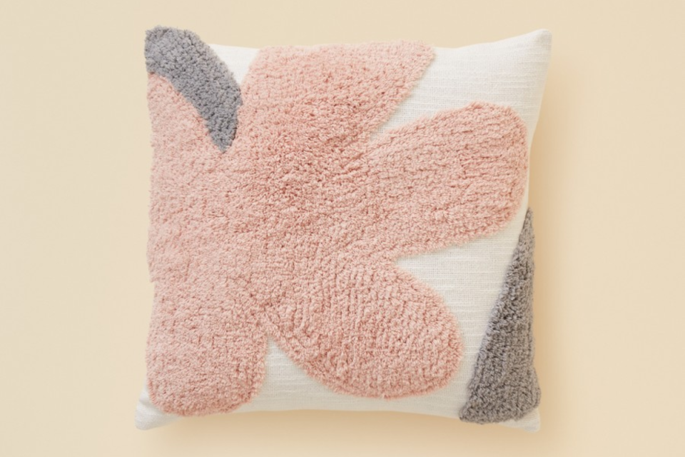 BIG W Tufted cushion with pink flower and grey details on a beige background