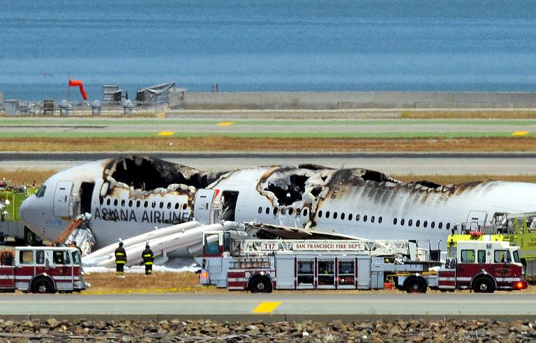 An Asiana Airlines Boeing 777 is seen on the runway at San Francisco International Airport after crash landing on July 6, 2013