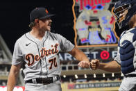 Detroit Tigers pitcher Tyler Alexander, left, gets a fist-bump from catcher Dustin Garneau after the sixth inning of a baseball game against the Minnesota Twins, Tuesday, Sept. 28, 2021, in Minneapolis. (AP Photo/Jim Mone)