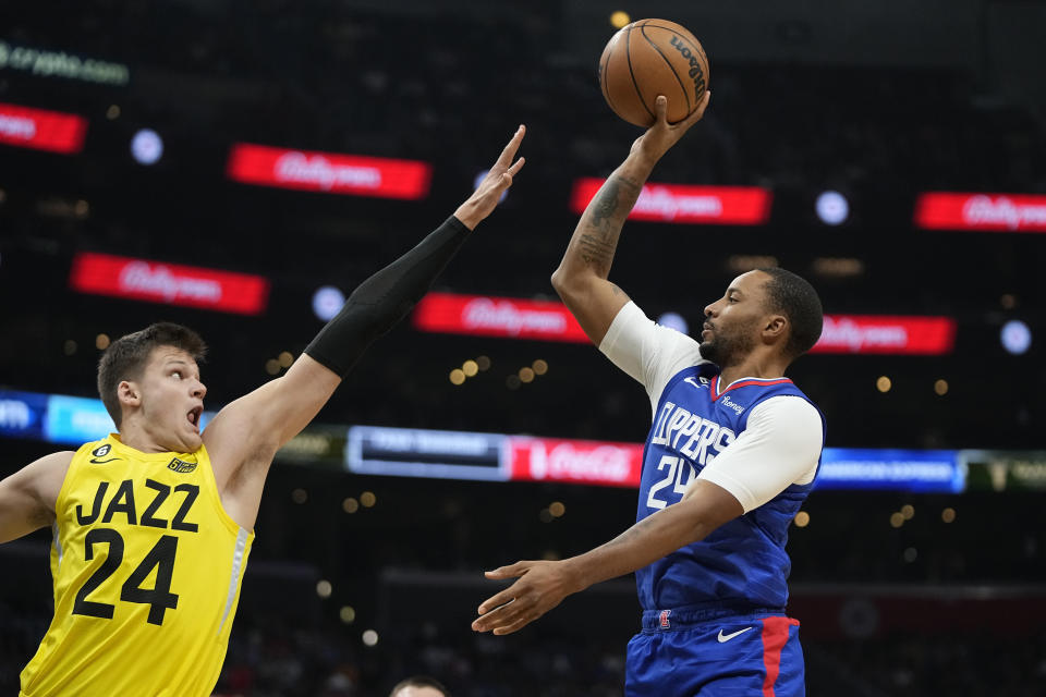 Los Angeles Clippers forward Norman Powell, right, shoots as Utah Jazz center Walker Kessler defends during the second half of an NBA basketball game Monday, Nov. 21, 2022, in Los Angeles. (AP Photo/Mark J. Terrill)