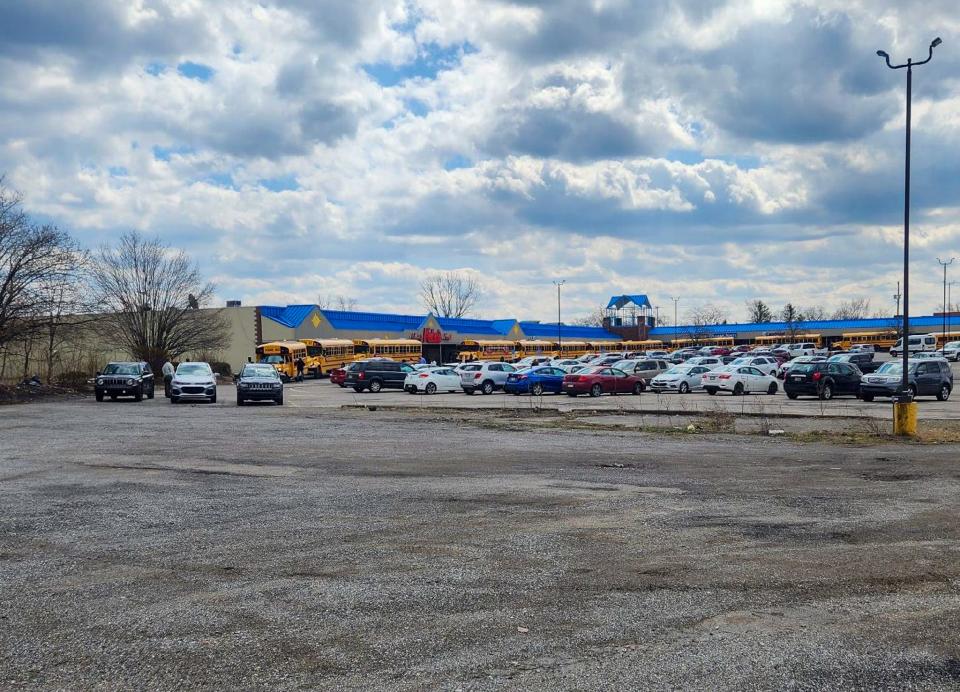 School buses pick up students outside of the Hopewell Shopping Center on March 29, 2023, after a swatting hoax caused a lockdown at the school district.