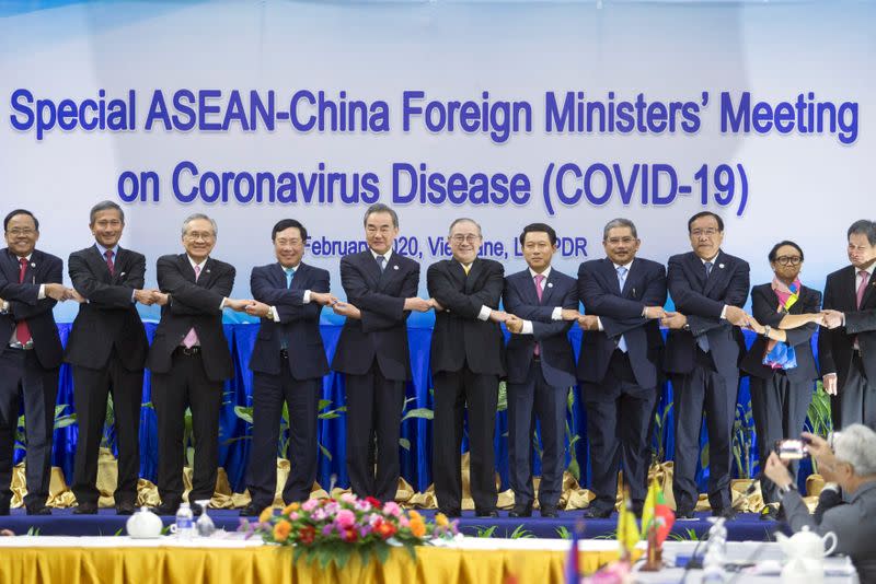 ASEAN foreign ministers pose during an emergency meeting with China's Foreign Minister Wang on the coronavirus outbreak in Vientiane