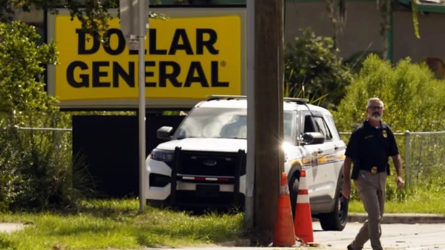 Law enforcement officials continue their investigation at a Dollar General store that was the scene of a mass shooting Sunday in Jacksonville, Florida. (Photo by John Raoux/AP)
