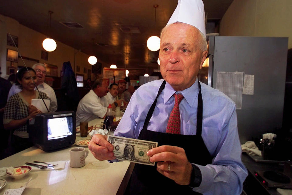 FILE - Los Angeles Mayor Richard Riordan picks up a tip from a customer at his restaurant "The Pantry," Friday, June 29, 2001 in downtown Los Angeles. Riordan, the moderate Republican multimillionaire who won two terms as mayor in Democrat-friendly Los Angeles and ran unsuccessfully for governor, died Wednesday, April 19, 2023. He was 92. (AP Photo/Damian Dovarganes, File)