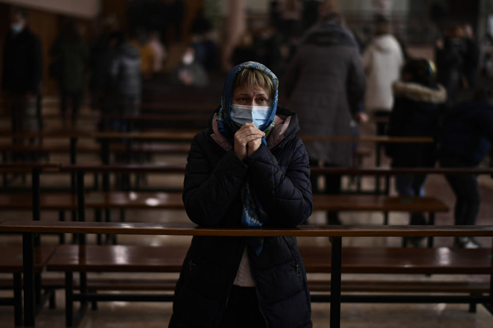 47 years old Oksana Khmelnytska Ukrainian resident prays during Orthodox mass, in Pamplona, northern Spain, Sunday, Feb. 27, 2022, to show their support for the people of Ukraine after the Russian invasion of Ukraine. (AP Photo/Alvaro Barrientos)