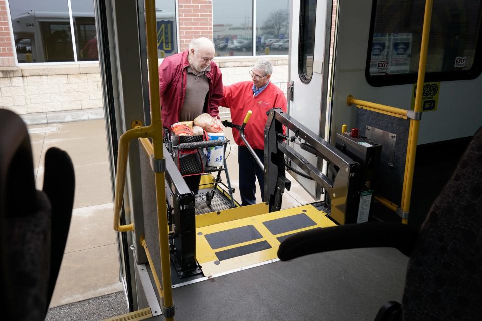 A helping hand from Quinten Bailey, driver of a Topeka Transit MOD bus, helps guide John Lester on board Wednesday from Dillons in southeast Topeka.