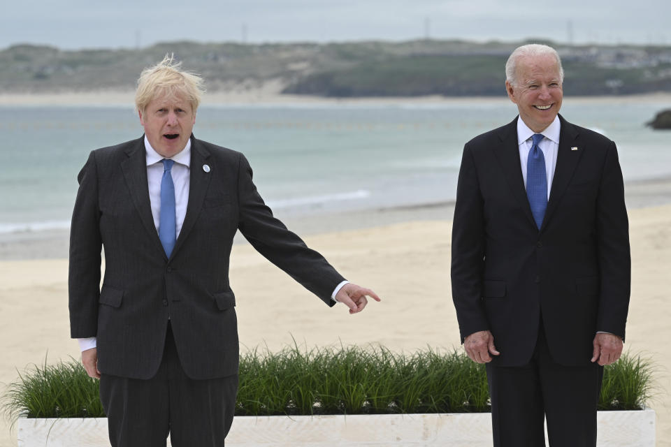 Britain's Prime Minister Boris Johnson, left and US President Joe Biden pose, during the Leaders official welcome and group photo session, during the G7 Summit in Carbis Bay, Cornwall, England, Friday, June 11, 2021. (Leon Neal/Pool Photo via AP)