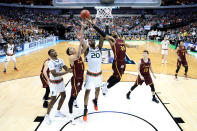 <p>Aundre Jackson #24 of the Loyola Ramblers and Ja’Quan Newton #0 of the Miami Hurricanes go for a loose ball in the second half in the first round of the 2018 NCAA Men’s Basketball Tournament at American Airlines Center on March 15, 2018 in Dallas, Texas. (Photo by Ronald Martinez/Getty Images) </p>