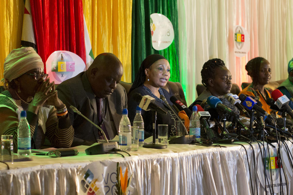 Zimbabwe Electoral Commission chairwoman Qhubani Moyo, center, announces the results of the presidential elections in Harare, Zimbabwe, Friday Aug. 3, 2018. Emmerson Mnangagwa, of ZANU-PF party was declared winner in the first vote after the fall of longtime leader Robert Mugabe. (AP Photo/Jerome Delay)