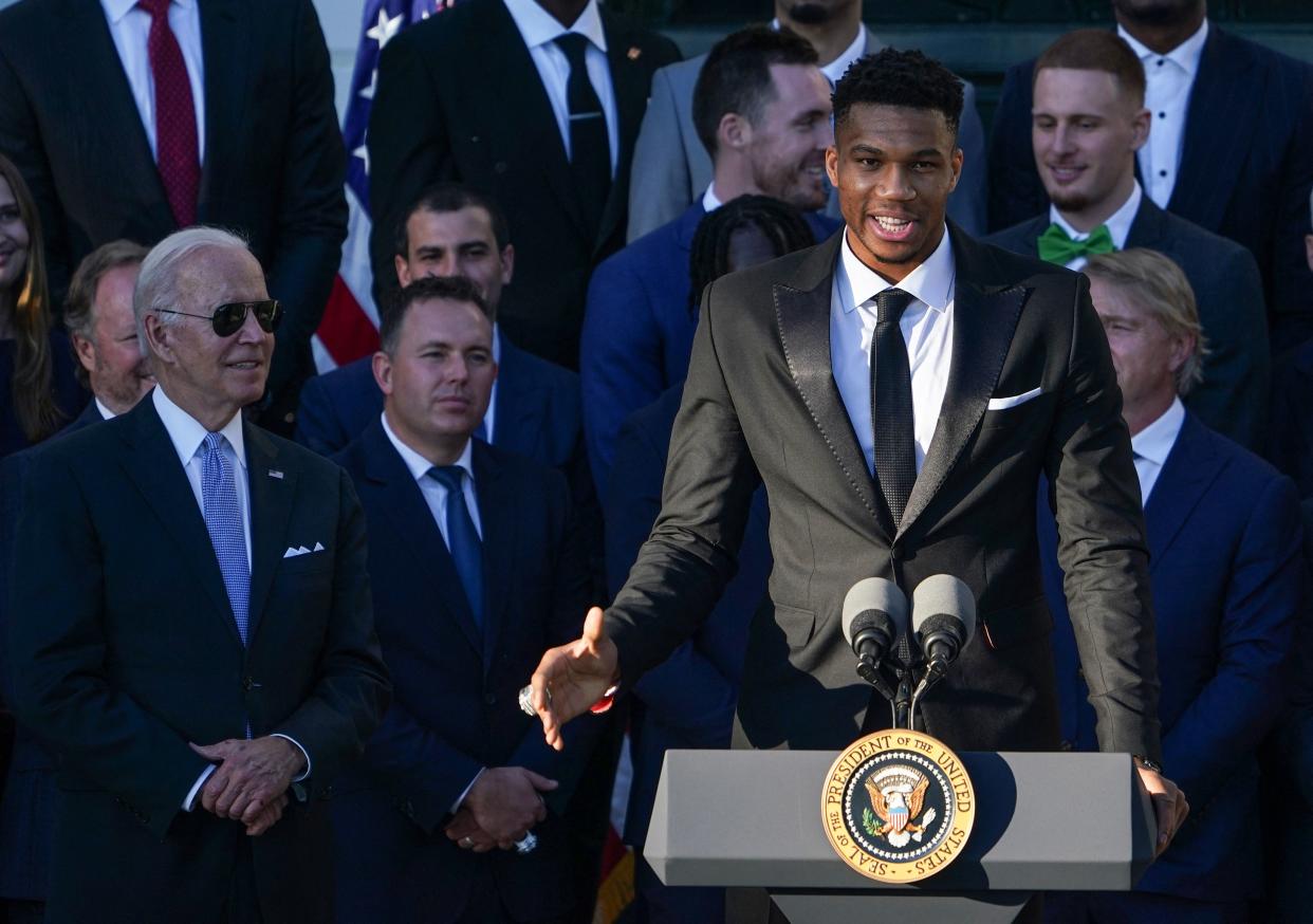 Giannis Antetokounmpo speaks as US President Joe Biden looks on during an event honoring the 2021 NBA Championship Milwaukee Bucks on the South Lawn of the White House in Washington, DC on November 8, 2021. (Photo by MANDEL NGAN / AFP) (Photo by MANDEL NGAN/AFP via Getty Images)
