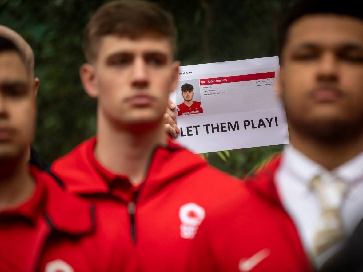 Alumni and supporters of the Simon Fraser University football program are pictured outside of B.C. Supreme Court in Vancouver on April 13. (Ben Nelms/CBC - image credit)