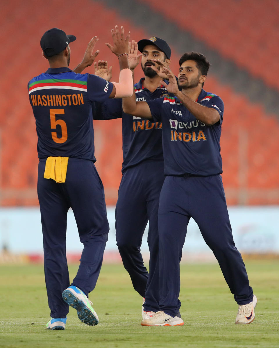 Shardul Thakur celebrates with Washington Sundar and KL Rahul after dismissing England captain Eoin Morgan during the 4th T20 International between India and England at Narendra Modi Stadium on March 18, 2021 in Ahmedabad, India.