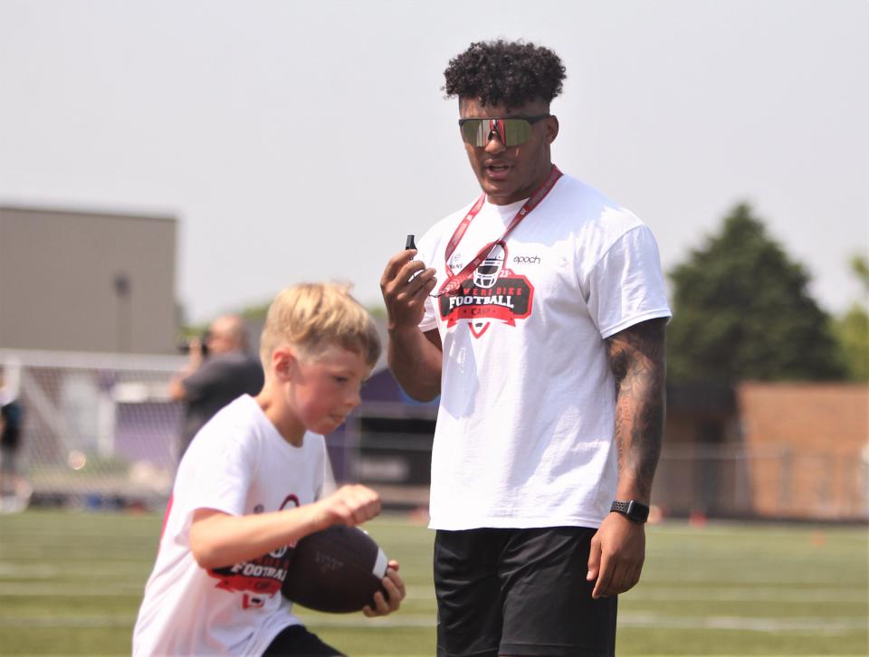 University of Wisconsin running back Braelon Allen, shown here helping with a drill during the second annual Chimere Dike football camp at Waukesha North High School on June 17, held his second annual charity softball game Saturday in Fond du Lac.