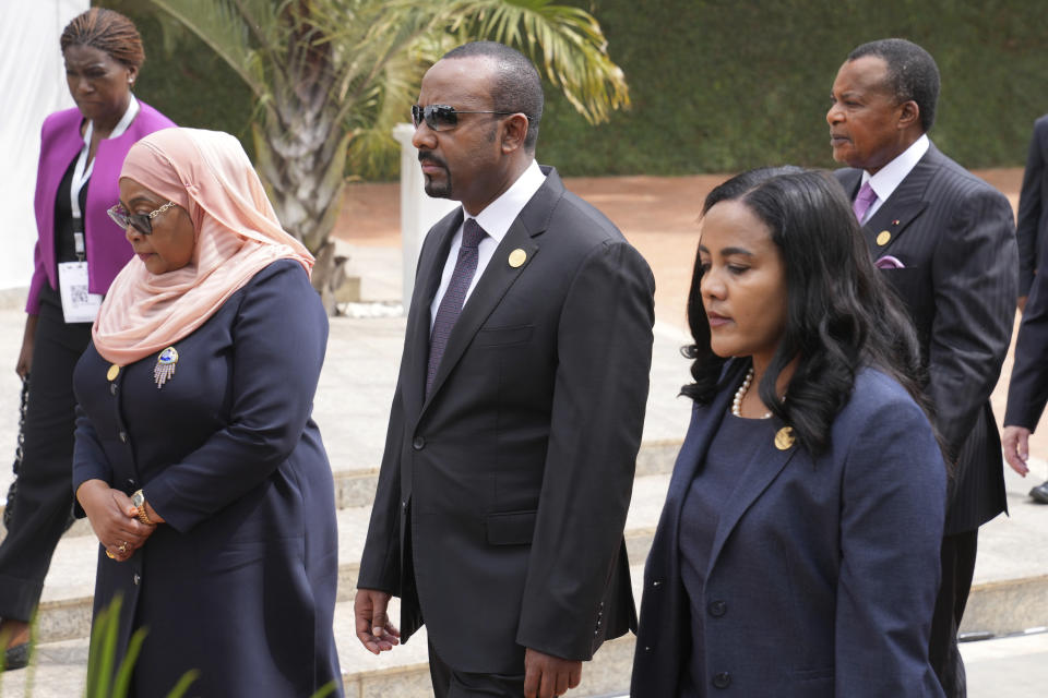 Tanzania's President Samia Suluhu Hassan, left, and Ethiopia's Prime Minister Abiy Ahmed with his wife Zinash Tayachew, right, arrive for a ceremony to mark the 30th anniversary of the Rwandan genocide, held at the Kigali Genocide Memorial, in Kigali, Rwanda, Sunday, April 7, 2024. Rwandans are commemorating 30 years since the genocide in which an estimated 800,000 people were killed by government-backed extremists, shattering this small east African country that continues to grapple with the horrific legacy of the massacres. (AP Photo/Brian Inganga)