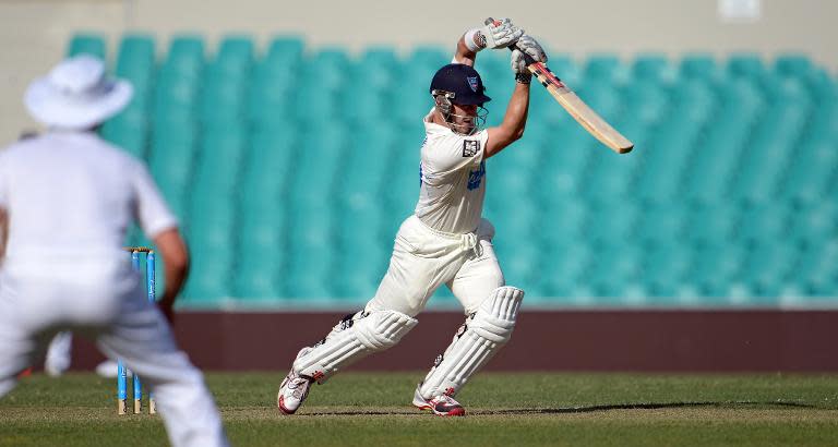 Cricket Australia Invitational XI captain Peter Nevill (C) plays a drive during the Ashes cricket match against England in Sydney on November 13, 2013