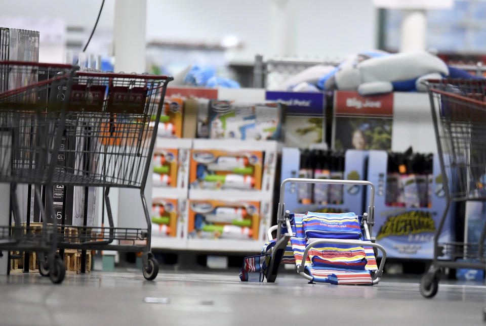 Scattered shopping carts and a flipped over beach chair lays on the ground following a shooting inside a Costco in Corona, Calif., Friday, June 14, 2019. A gunman opened fire inside the store during an argument, killing a man, wounding two other people and sparking a stampede of terrified shoppers before he was taken into custody, police said. The man involved in the argument was killed and two other people were wounded, Corona police Lt. Jeff Edwards said. (Will Lester/Inland Valley Daily Bulletin/SCNG via AP)