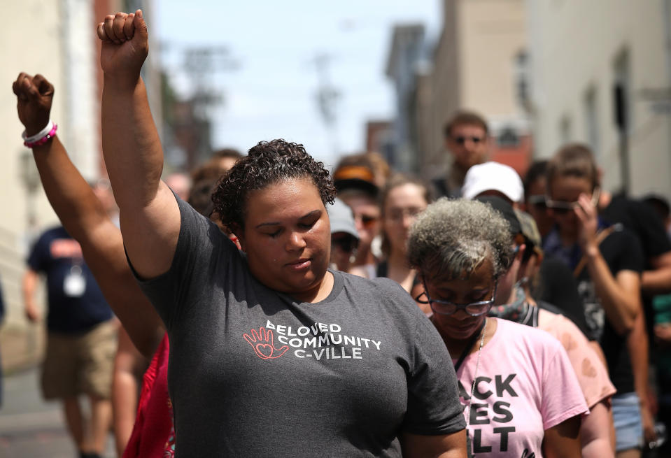 <p>Members of the Charlottesville community gather near a makeshift memorial for Heather Heyer, who was killed one year ago during a deadly clash, August 12, 2018 in Charlottesville, Virginia. Charlottesville has been declared in a state of emergency by Virginia Gov. Ralph Northam as the city braces for the one year anniversary of the deadly clash between white supremacist forces and counter protesters over the potential removal of Confederate statues of Robert E. Lee and Jackson. A “Unite the Right” rally featuring some of the same groups is planned for Washington, DC. (Photo: Win McNamee/Getty Images) </p>