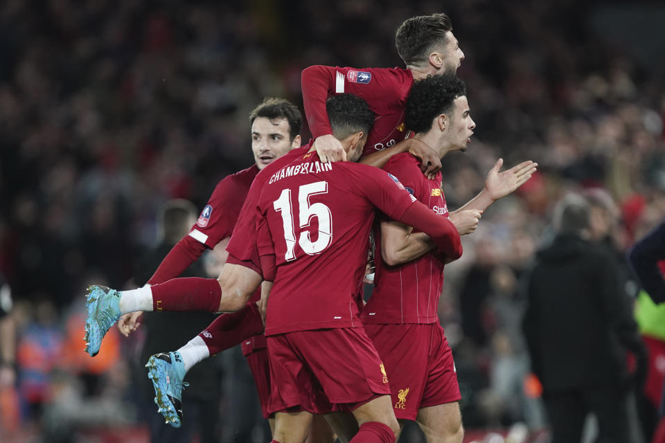 Liverpool's Curtis Jones, right, celebrates with his teammates after scoring his side's opening goal during the English FA Cup third round soccer match between Liverpool and Everton at Anfield stadium in Liverpool, England, Sunday, Jan. 5, 2020. (AP Photo/Jon Super)